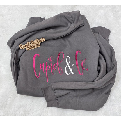 Real charcoal Cupid & Co embroidered Valentine sweatshirt with bright pink and white stitching.