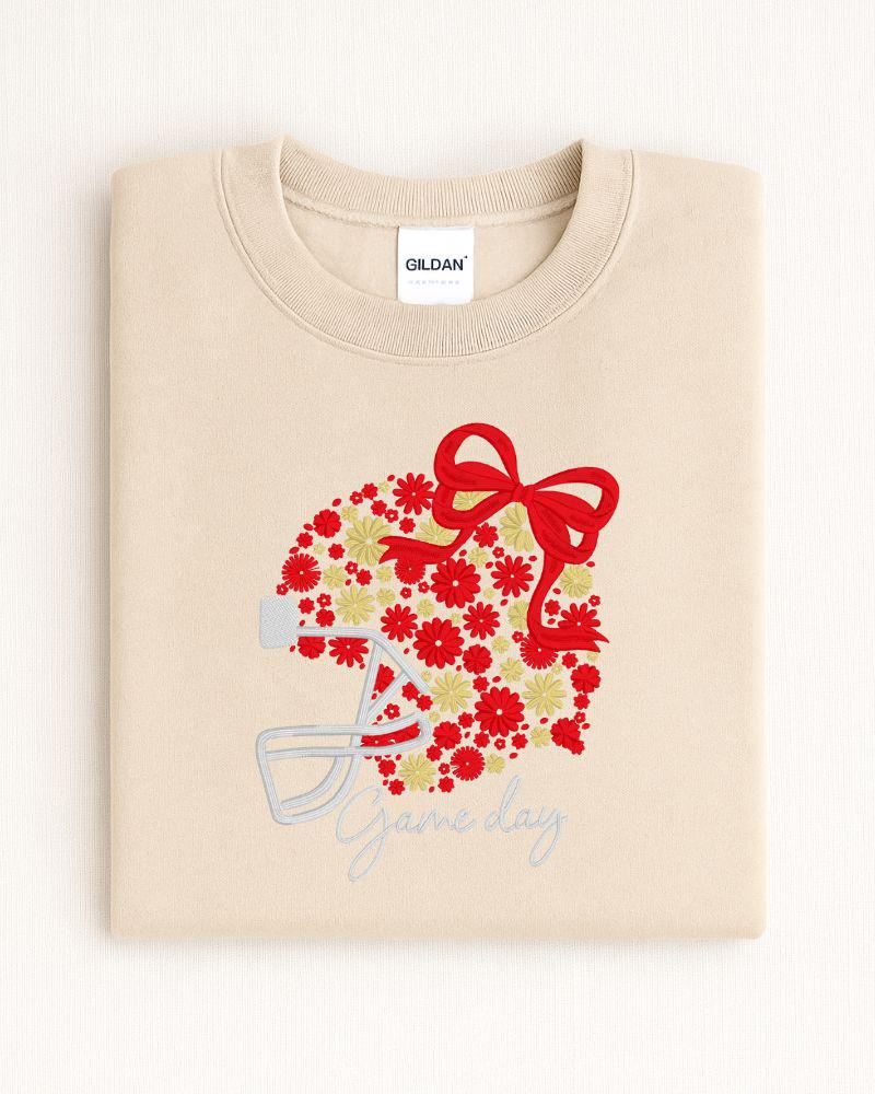 Sand Gildan sweatshirt with red floral football helmet bow and Game Day embroidery