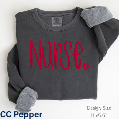 Folded pepper Comfort Colors sweatshirt with custom Nurse script embroidery
