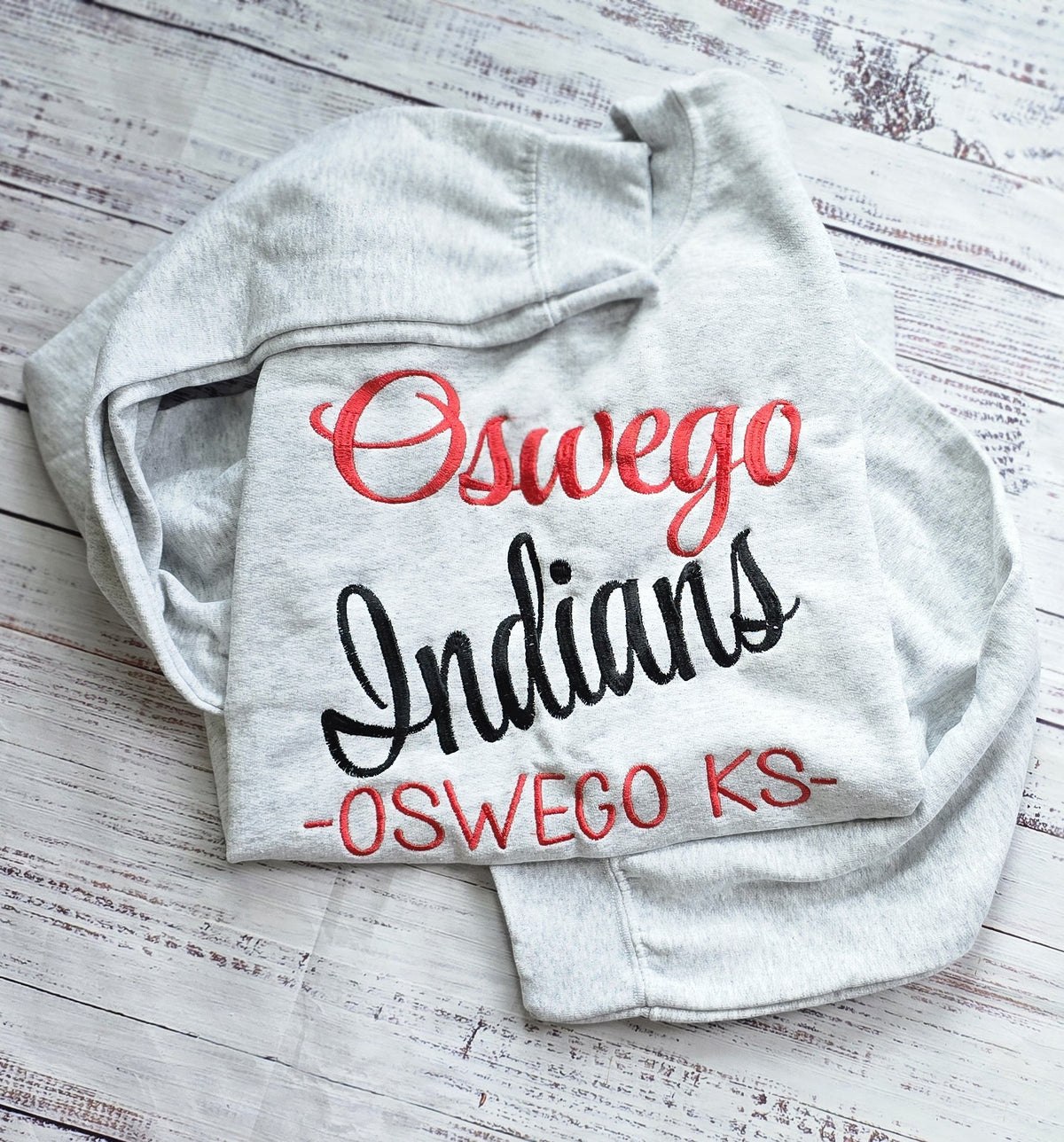 Ash crewneck showing large full-chest custom word embroidery