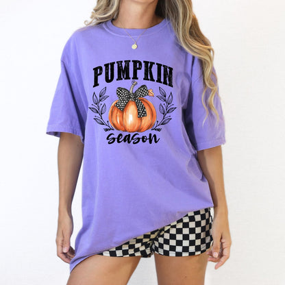 Cute pumpkin bow shirt styled as a relaxed fall festival outfit.