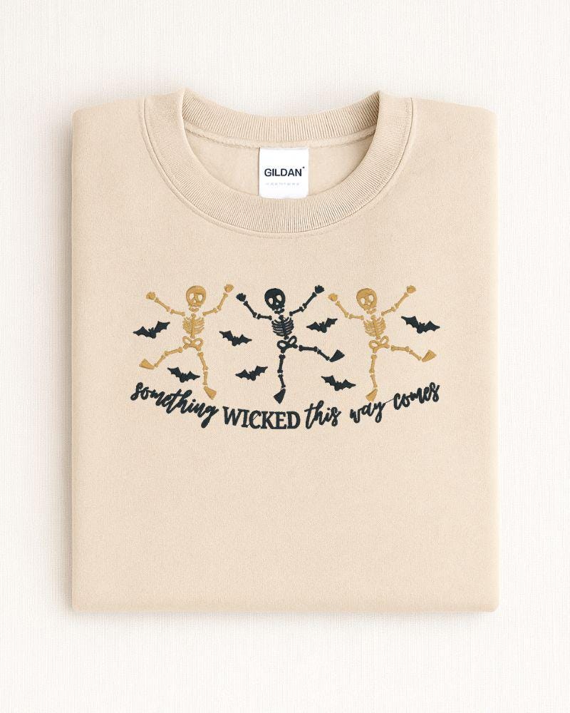 Dancing skeleton Halloween embroidered crewneck shown as a cozy spooky season outfit