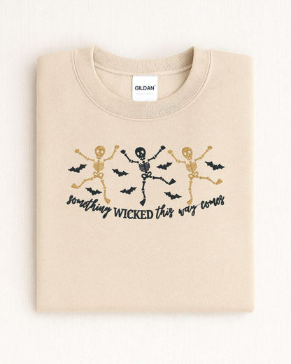 Dancing skeleton Halloween embroidered crewneck shown as a cozy spooky season outfit