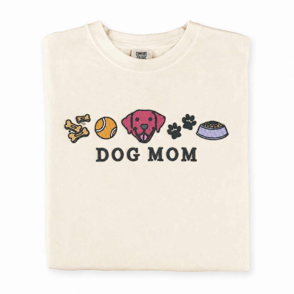 Folded Ivory Comfort Colors 1717 T-shirt with colorful Dog Mom embroidery