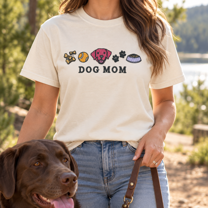 Ivory Dog Mom embroidered T-shirt worn outdoors with a chocolate Labrador
