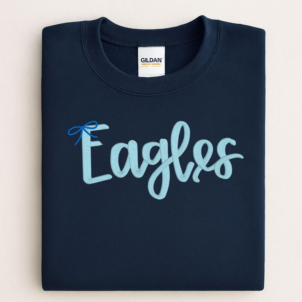 Navy Eagles script sweatshirt modeled while holding a white pumpkin