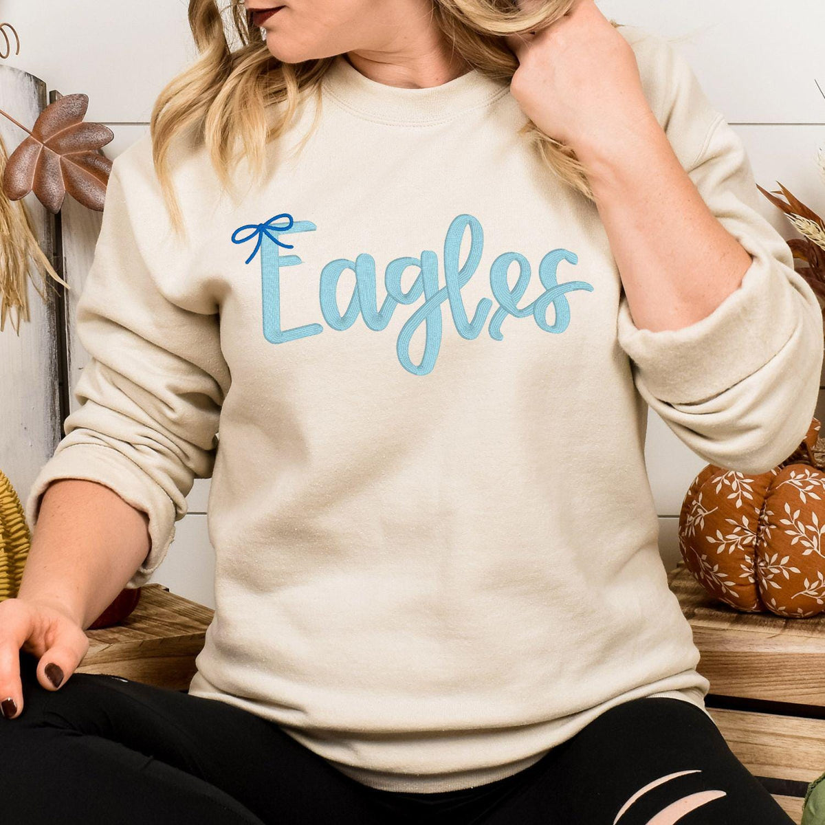 Sand Eagles script and bow embroidered sweatshirt folded flat