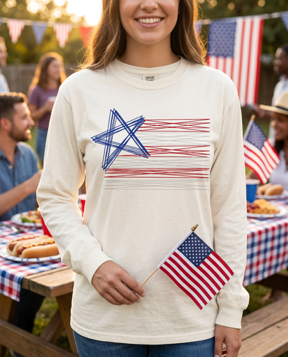 Woman wearing cream embroidered American flag long sleeve patriotic shirt holding USA flag