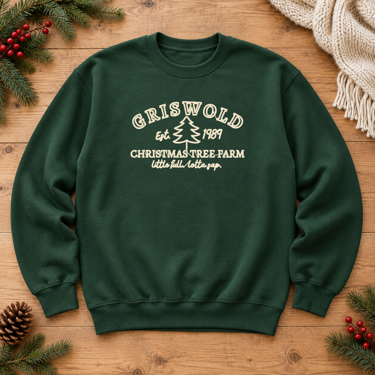 Forest green Christmas tree farm embroidered sweatshirt flat lay with evergreen holiday accents