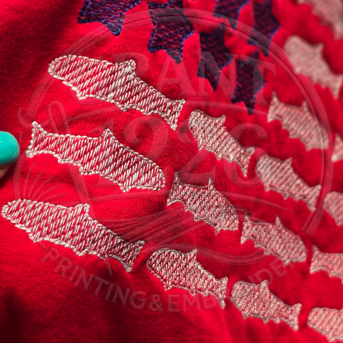 Close-up of red, white, and blue embroidered fish flag details