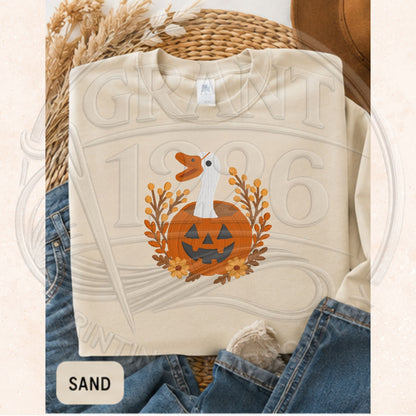 Sand Gildan heavyweight sweatshirt flat lay with embroidered jack-o'-lantern goose design