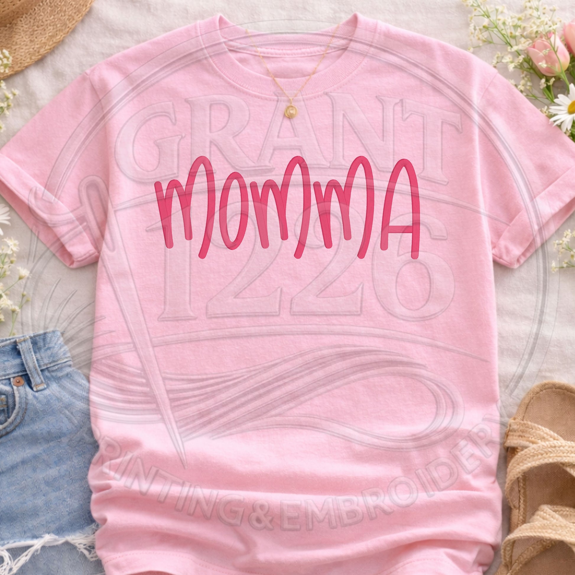 pink embroidered mama shirt styled flatlay with jeans and accessories