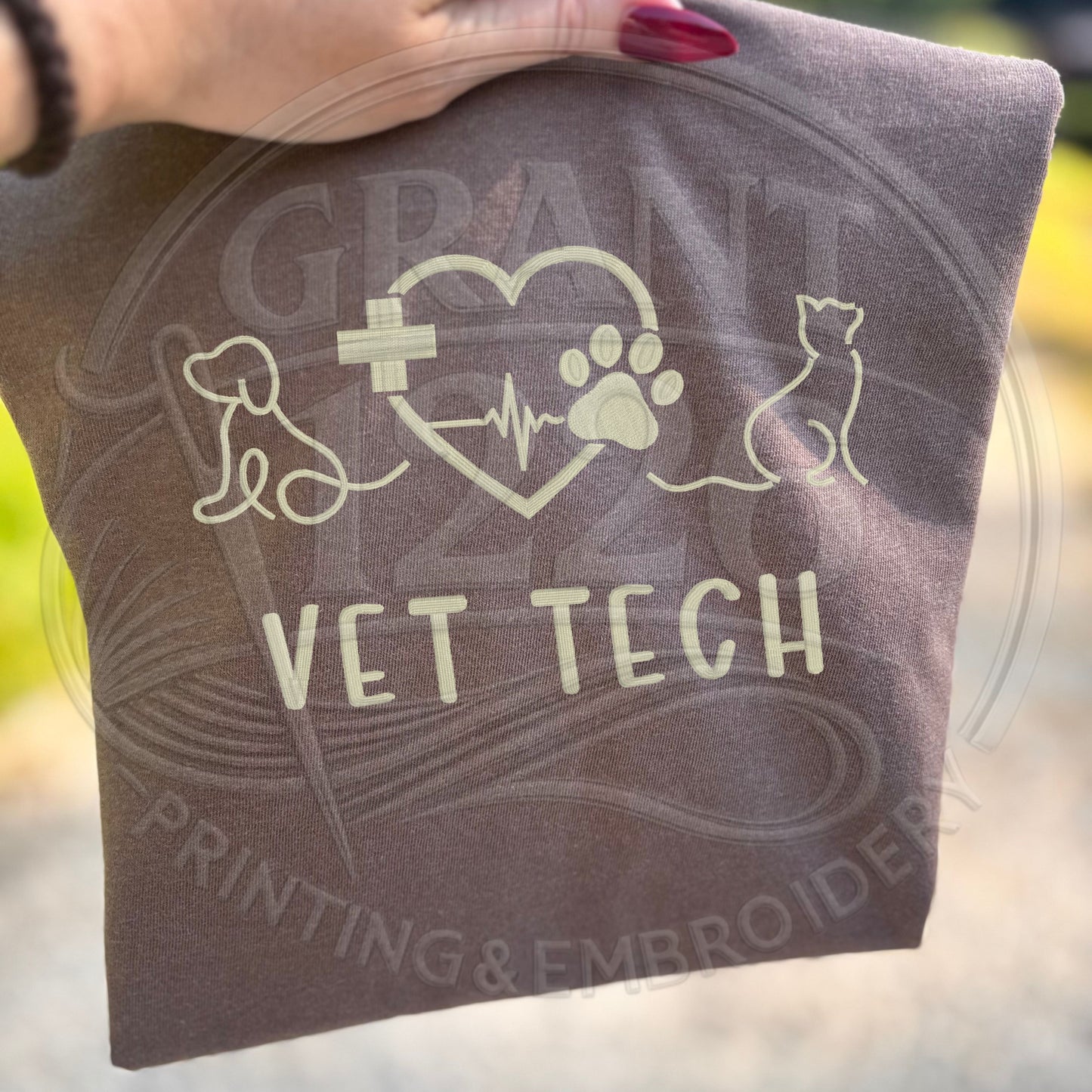 Folded embroidered vet tech gift shirt with dog and cat design