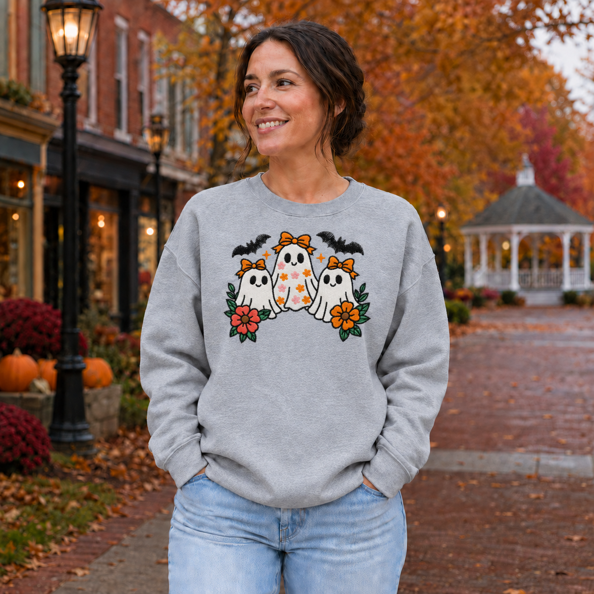 Adult wearing Sport Grey embroidered white ghost trio sweatshirt with orange bows and flowers