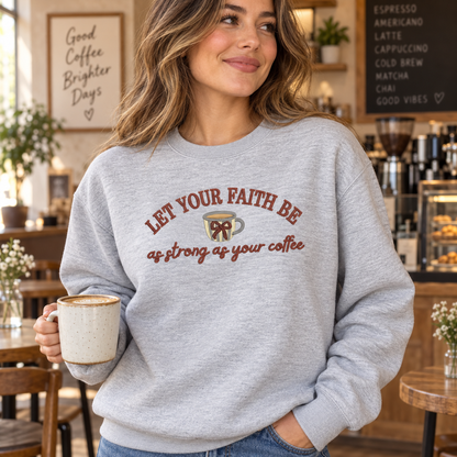 Woman holding coffee in an ash Gildan Softstyle sweatshirt with faith and coffee embroidery