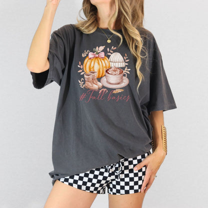 Woman wearing a Pepper Comfort Colors Fall Basics shirt with pumpkin coffee boots and knit hat graphic