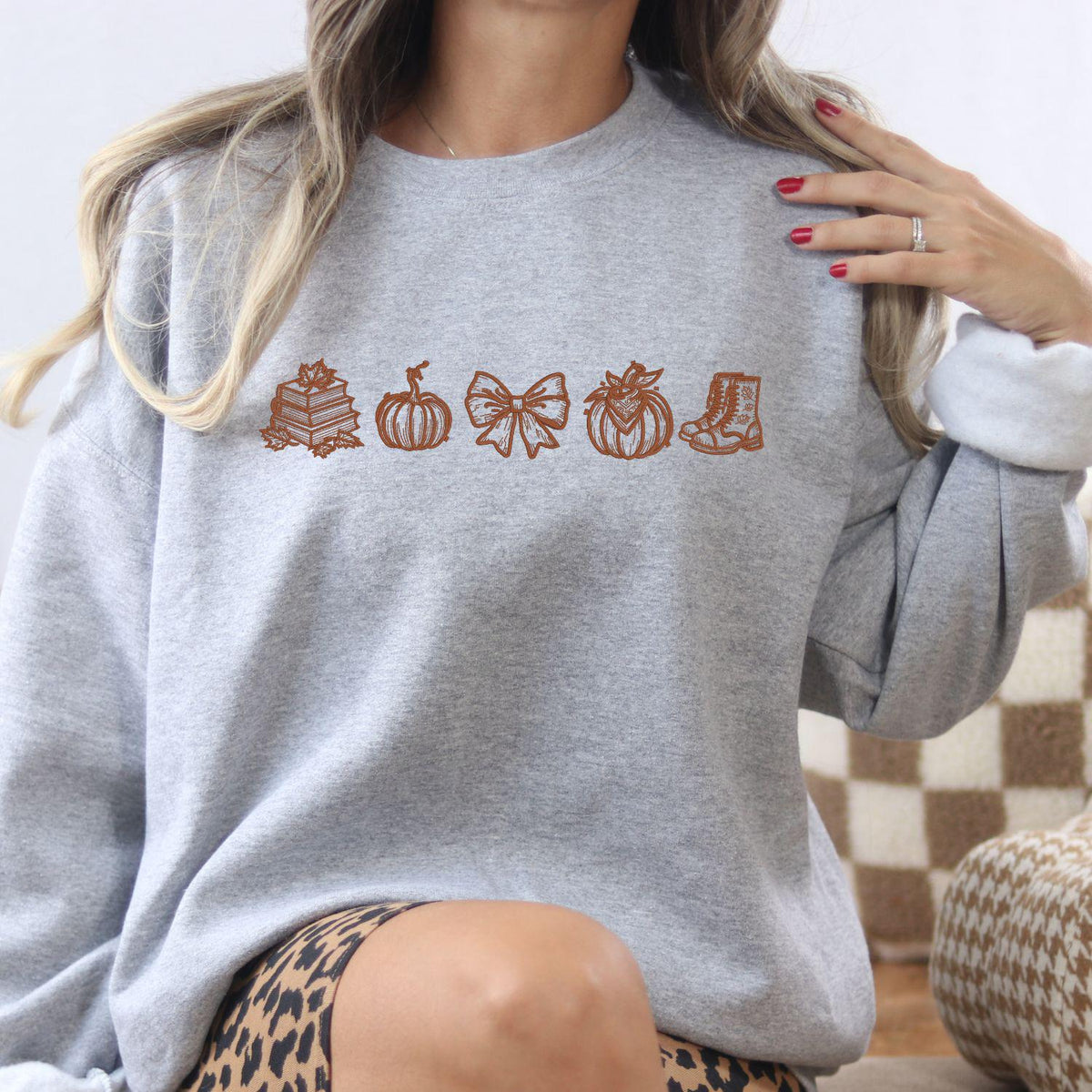 Ash fall reader embroidered crewneck with book, pumpkin, bow and boot icons