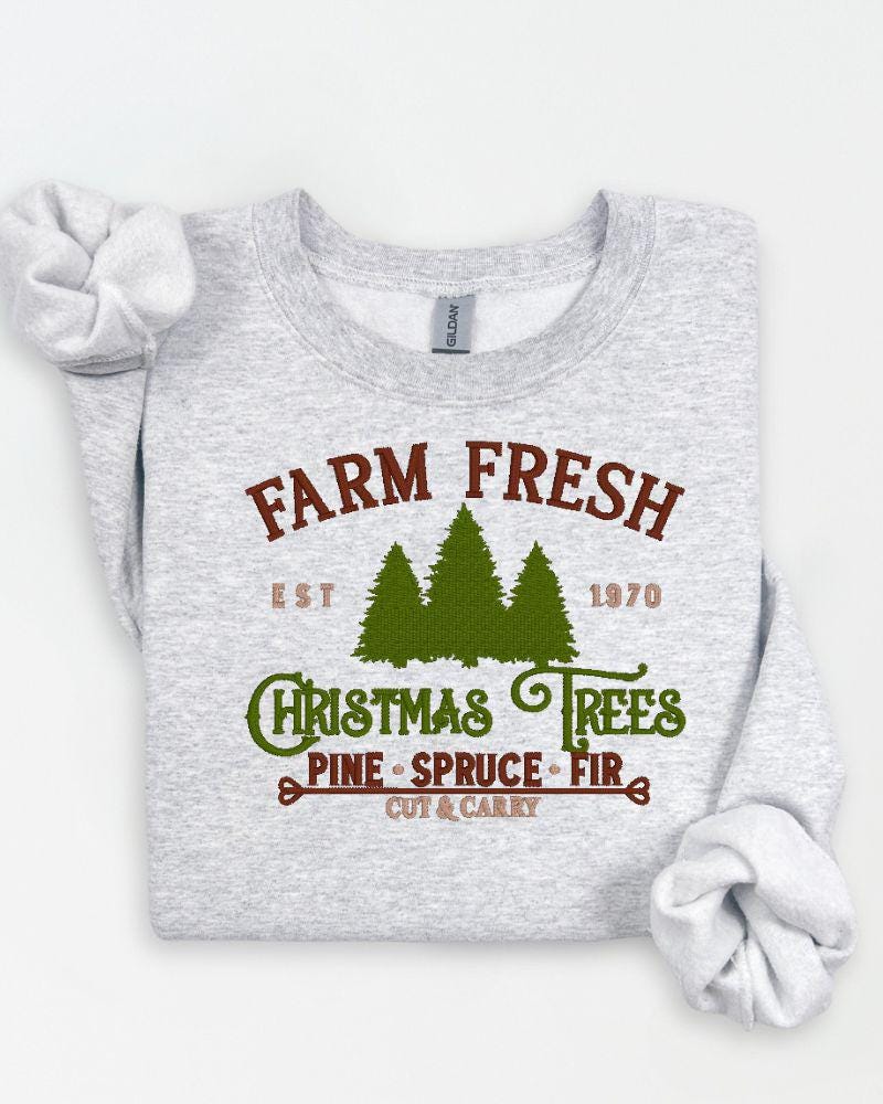 Close-up of Farm Fresh Christmas Trees lettering machine embroidered on a Gildan crewneck.