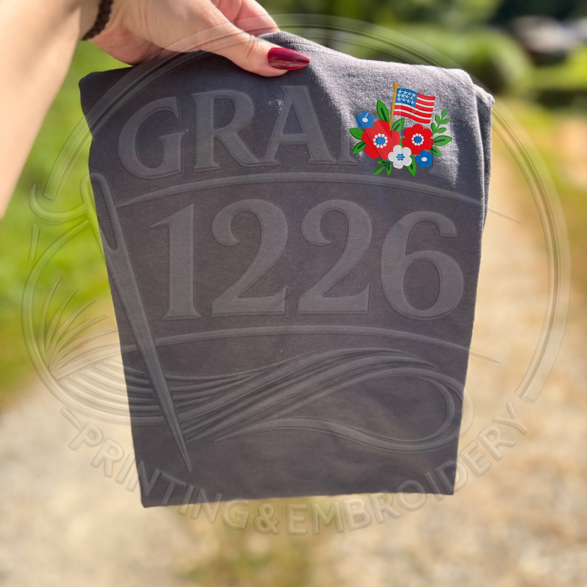 Charcoal patriotic embroidered T-shirt with red white and blue floral flag