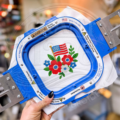Machine embroidery hoop stitching floral American flag design on white fabric