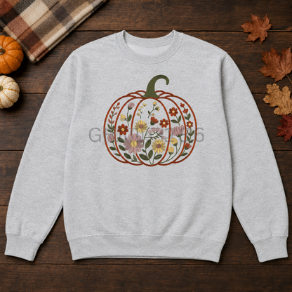 Ash Gildan Softstyle sweatshirt with centered floral garden pumpkin embroidery in an autumn flat lay