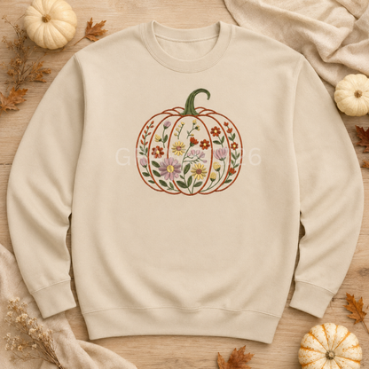 Sand Gildan Softstyle sweatshirt with centered floral garden pumpkin embroidery in an autumn flat lay