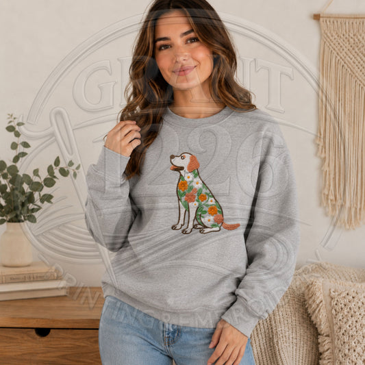 Woman modeling a gray embroidered Labrador Retriever sweatshirt with orange, white and green floral details.