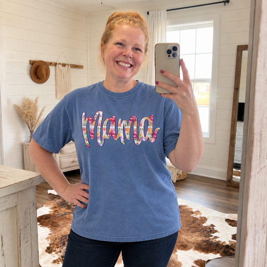 Woman modeling Blue Jean Comfort Colors floral Mama graphic shirt