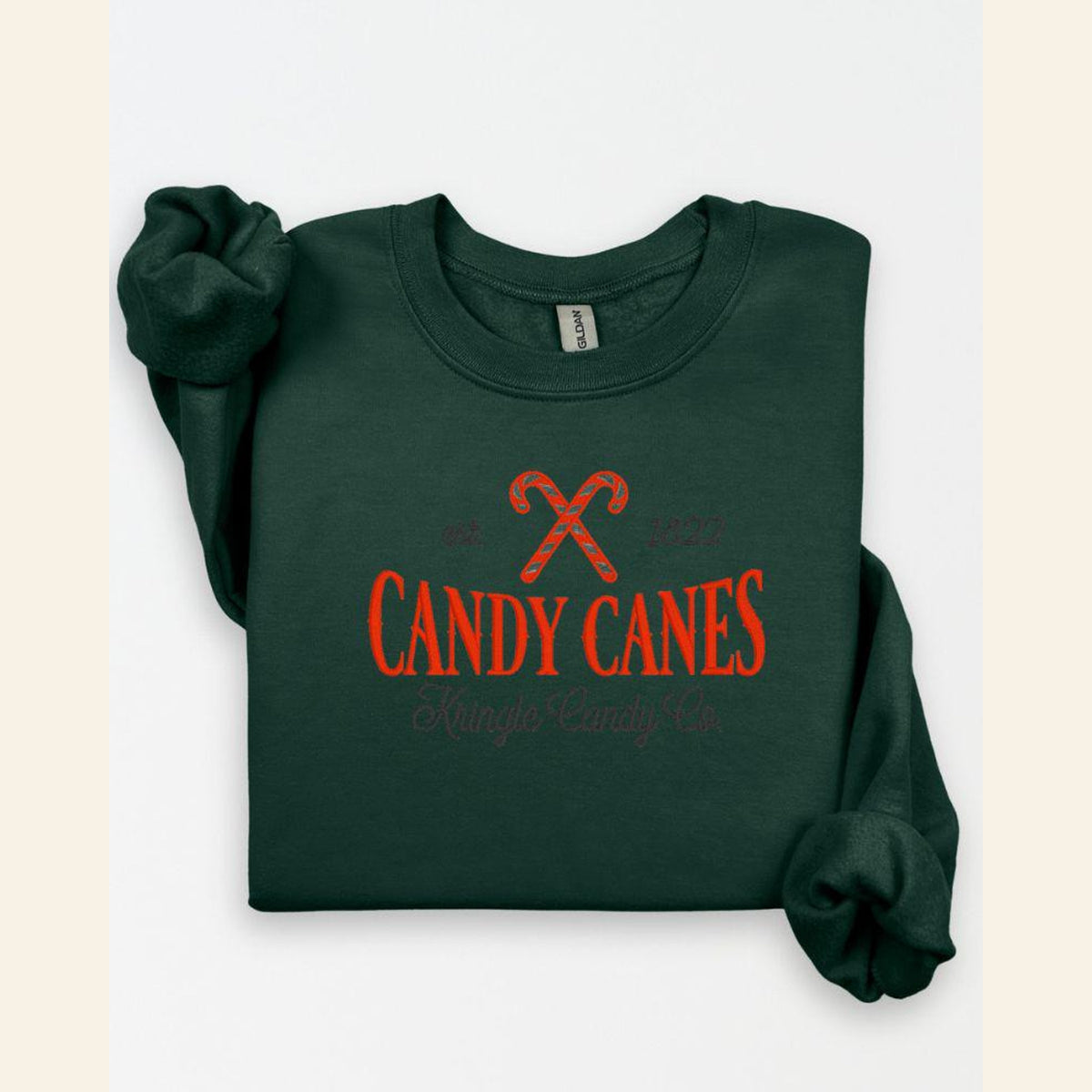 Forest Green Candy Cane Kringle Candy Co embroidered Christmas sweatshirt flat lay
