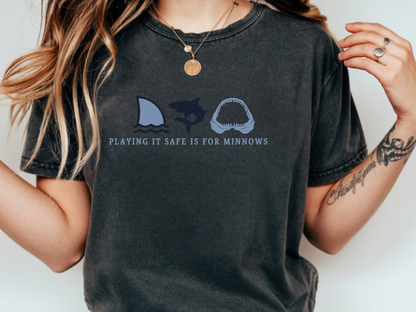 Person wearing a pepper t-shirt with shark and fox graphic and text.