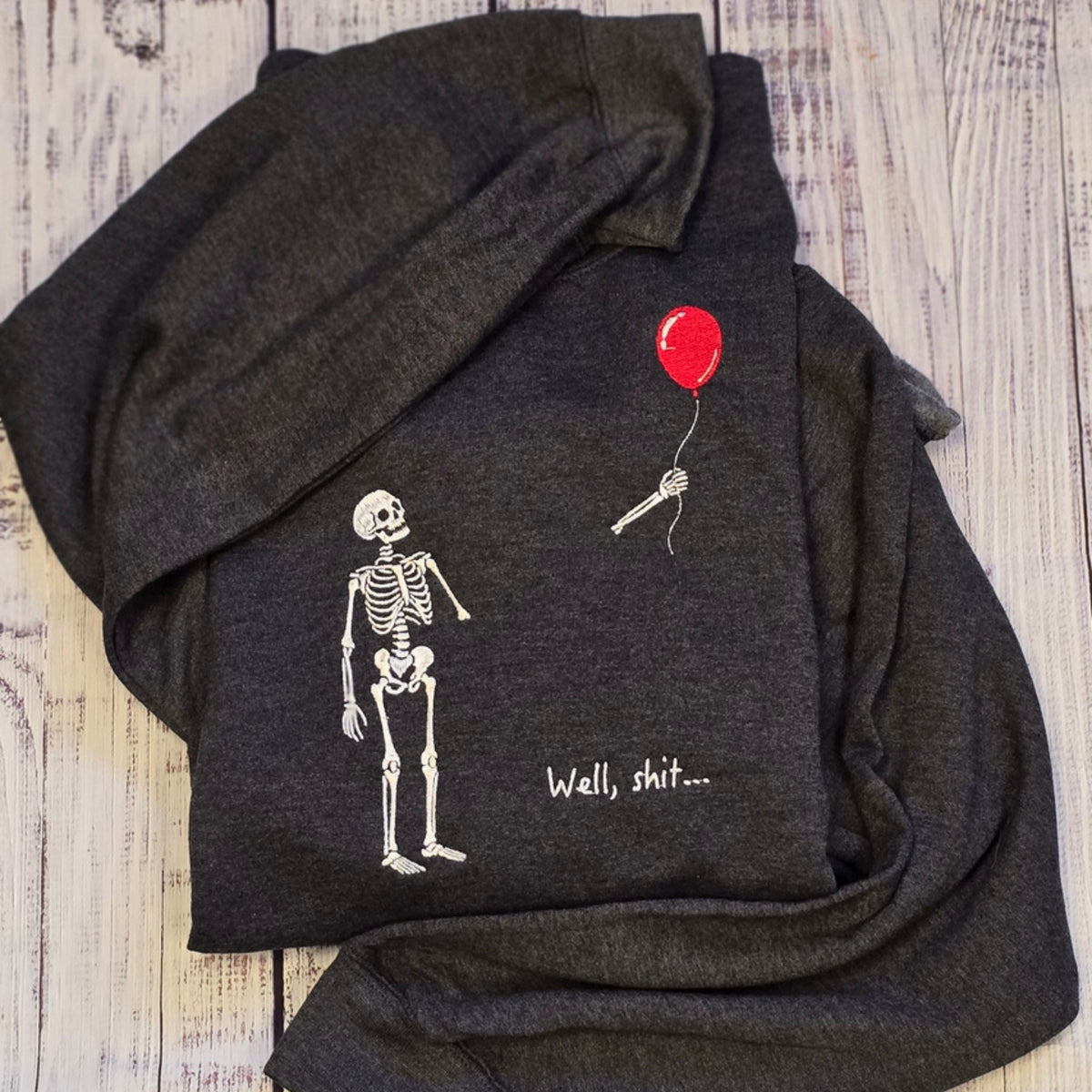 Funny skeleton and red balloon embroidery on Heather Black Gildan Softstyle crewneck sweatshirt