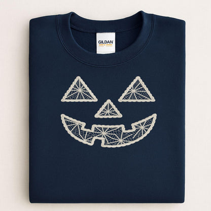 Folded navy crewneck with geometric pumpkin face embroidery