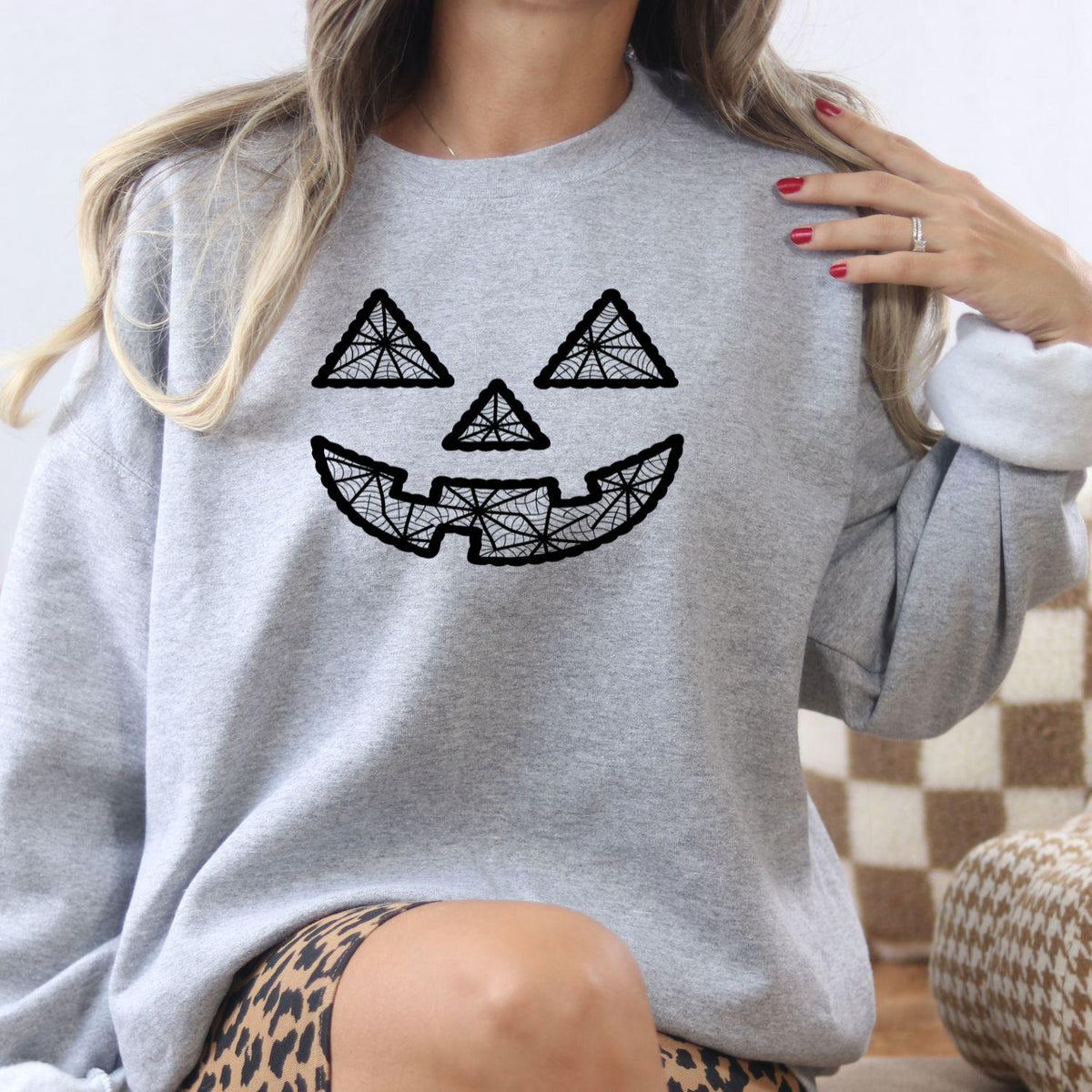 Model wearing sport gray geometric jack-o-lantern embroidered sweatshirt