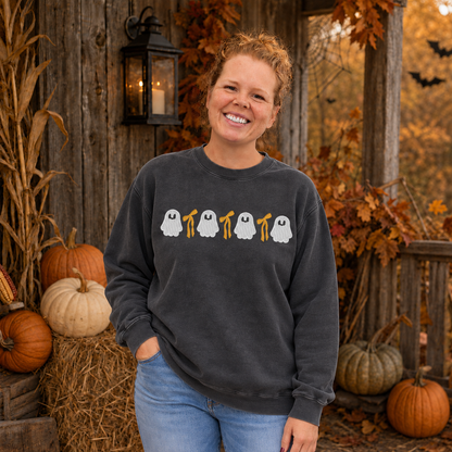 Samantha wearing a Pepper ghost and bow embroidered sweatshirt on a rustic Halloween porch