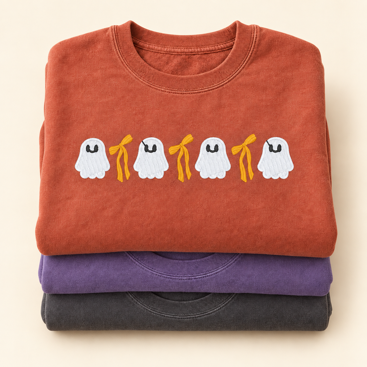 Folded Pepper Violet and Terracotta ghost and bow sweatshirts shown together