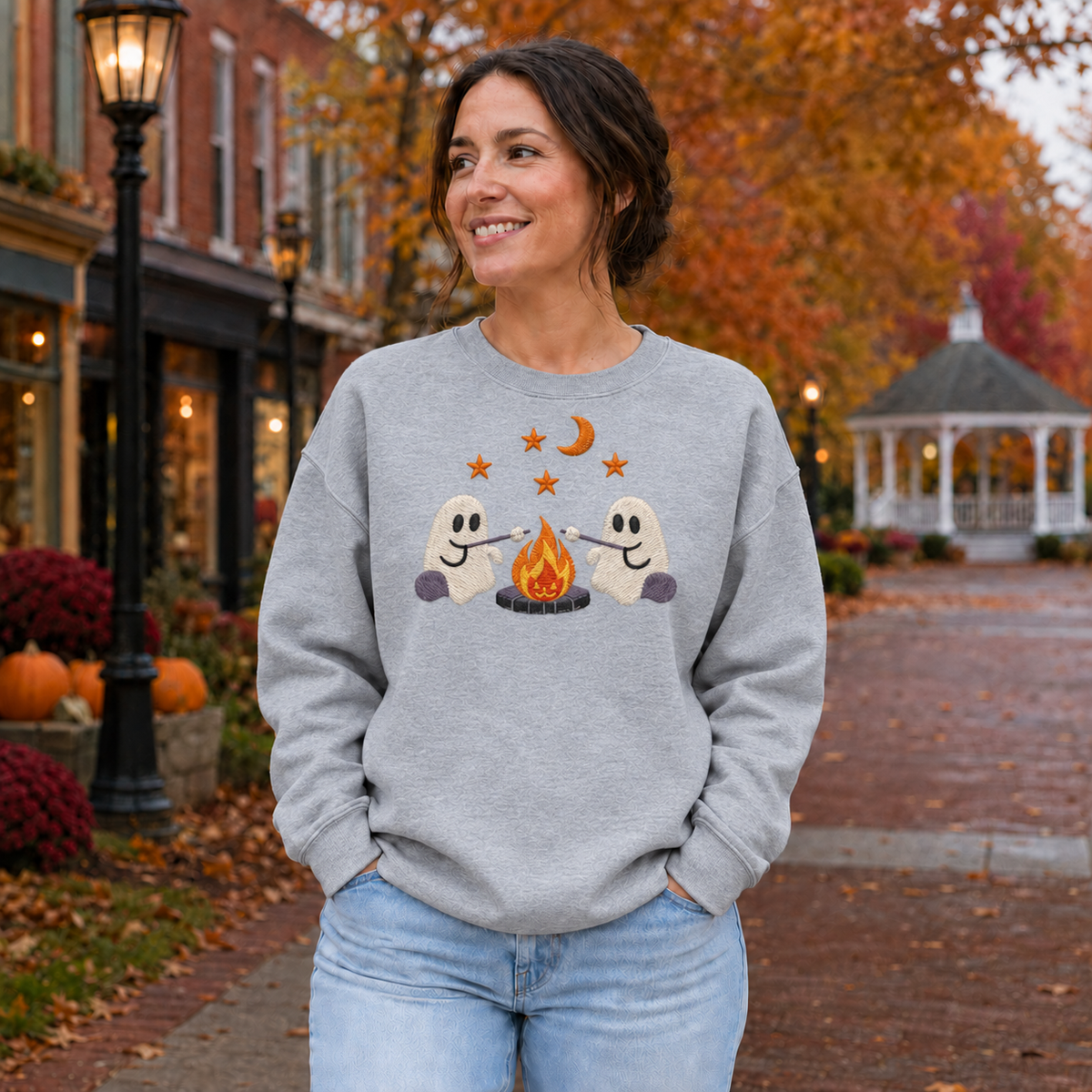 Adult wearing Sport Grey embroidered ghost campfire sweatshirt with two ghosts roasting marshmallows