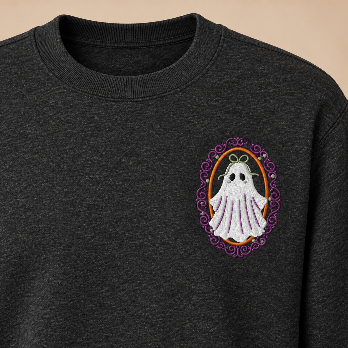 Cropped upper-chest view showing the collar, shoulder seam, and true left-chest placement of the framed ghost embroidery.