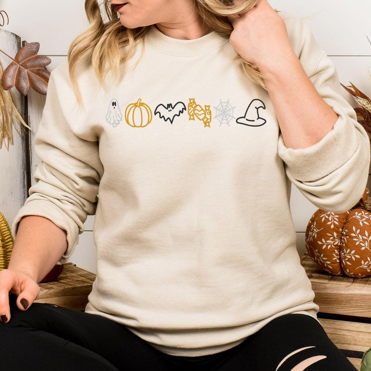 Sand embroidered crewneck with ghost, pumpkin, bat, candy, spiderweb and witch hat icons