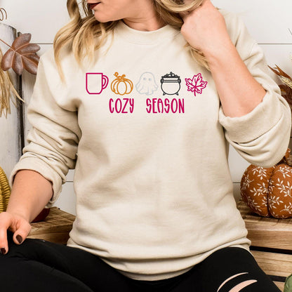 Sand embroidered Cozy Season sweatshirt with colorful fall and Halloween icons