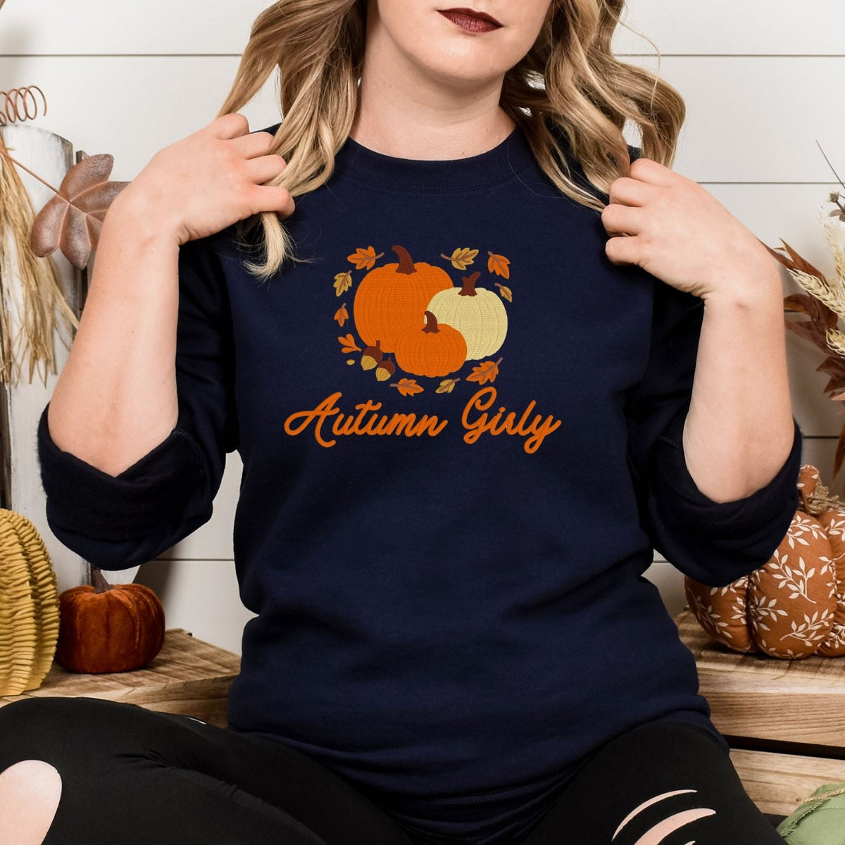 Navy Gildan 18000 embroidered pumpkin and leaves sweatshirt on a model
