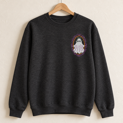 Heathered-black Gildan Softstyle crewneck on a wooden hanger showing the embroidered ghost over the left chest.