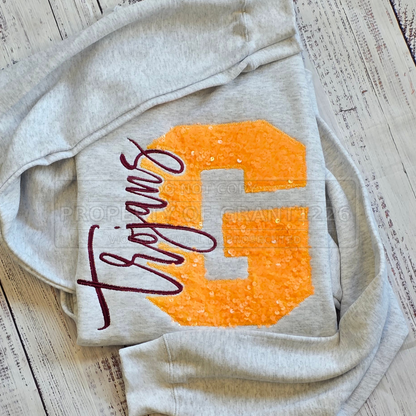 Girard school spirit crewneck with sparkling gold G appliqué and burgundy Trojans embroidery