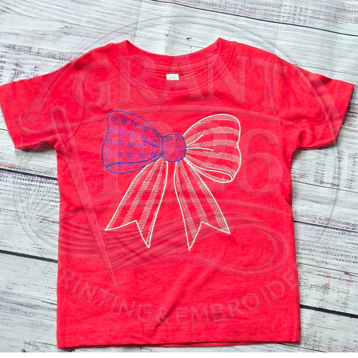 Red kids shirt with embroidered red, white, and blue gingham bow