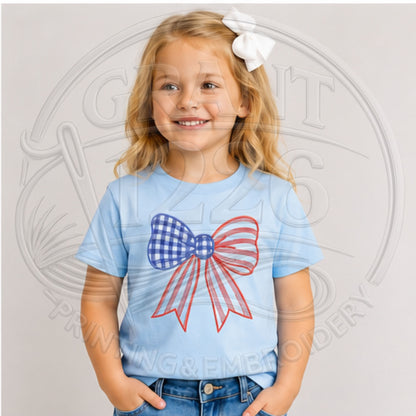 Child wearing Light Blue embroidered red, white, and blue gingham bow shirt