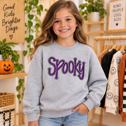 Girl wearing a heather gray youth Spooky puff embroidered Halloween sweatshirt