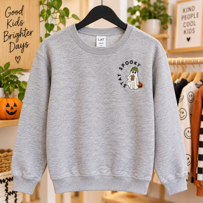 Girl wearing a Heather LAT sweatshirt with Stay Spooky Halloween ghost embroidery on the left chest