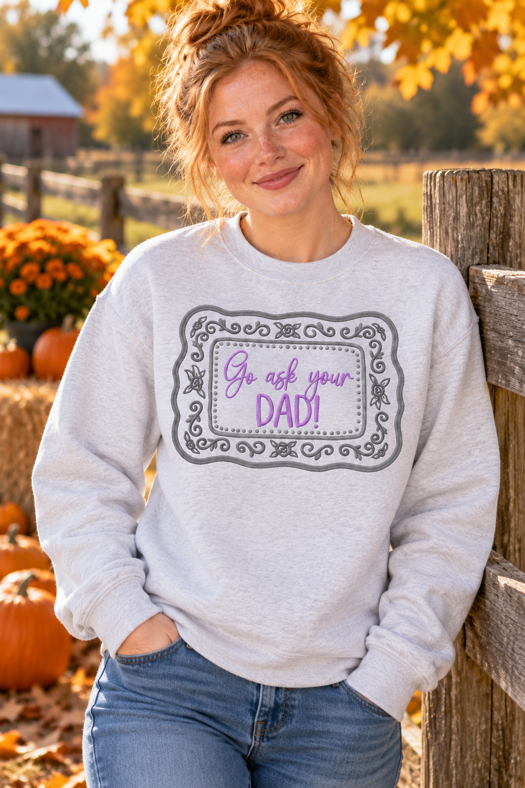 Woman wearing Ash Go Ask Your Dad embroidered sweatshirt at a fall farm