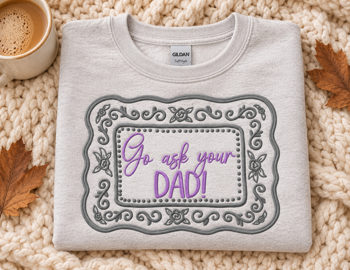 Folded Ash embroidered Go Ask Your Dad sweatshirt with grey floral frame and lavender wording