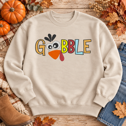 Sand Gobble turkey embroidered sweatshirt flat lay with pumpkins and fall leaves