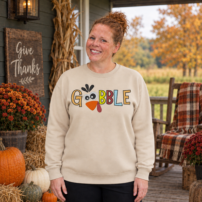 Samantha wearing a Sand Gobble turkey embroidered Thanksgiving sweatshirt on a rustic fall porch